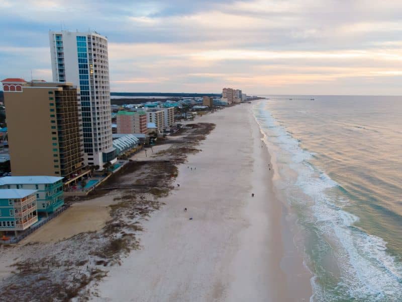 Aerial view of beachfront properties and coastline in Gulf Shores, Alabama for land surveying and coastal property mapping