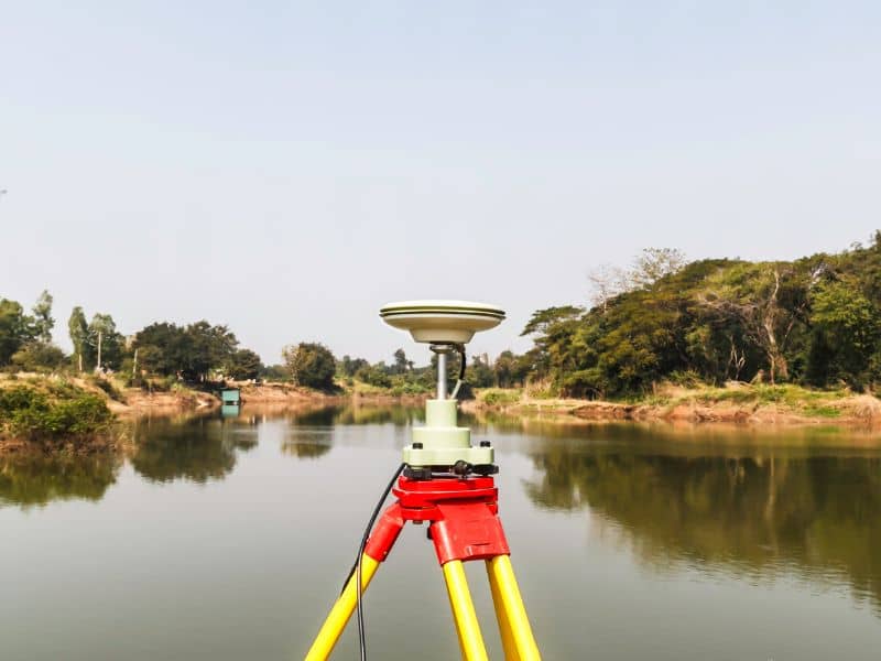 Surveying equipment positioned along a shoreline to establish accurate waterfront property boundaries